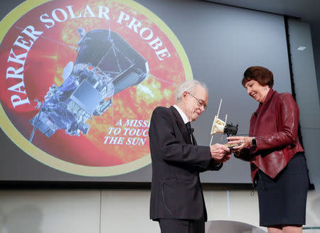 Dr. Eugene Parker, University of Chicago astrophysicist, (L), receives a first scale model of Parker Solar Probe from Dr. Nicola Fox, project scientist for the Solar Probe Plus, (R), during the NASA announcement on its first mission to fly directly into the sun's atmosphere at the University of Chicago in Chicago, Illinois, U.S. May 31, 2017. REUTERS/Kamil Krzaczynski