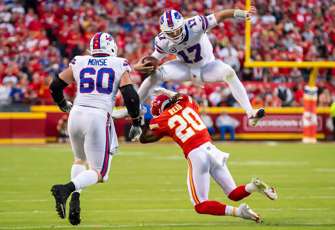 Buffalo Bills quarterback Josh Allen leaps over Kansas City Chiefs safety Justin Reid during Sunday’s game at GEHA Field at Arrowhead Stadium.