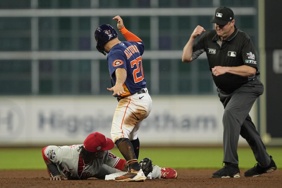 Houston Astros' Jose Altuve is tagged out by Philadelphia Phillies second baseman Jean Segura after an attempted steal during the seventh inning in Game 2 of baseball's World Series between the Houston Astros and the Philadelphia Phillies on Saturday, Oct. 29, 2022, in Houston. (AP Photo/David J. Phillip)