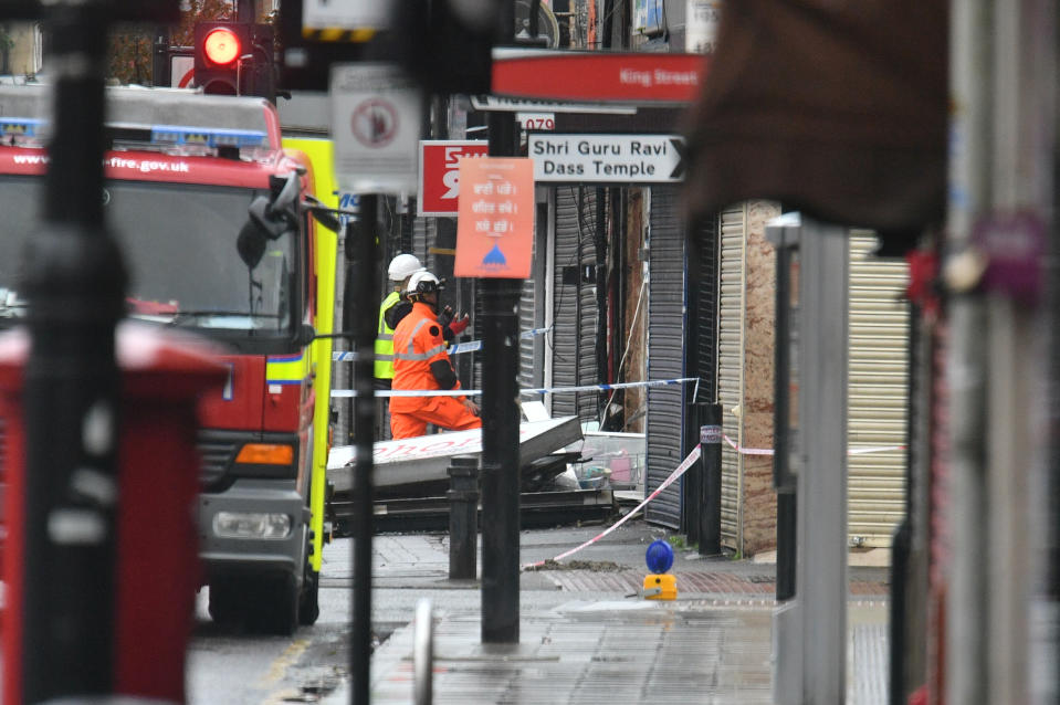 Emergency services inspecting damage at the scene of a suspected gas explosion on King Street in Ealing, west London. Rescuers are involved in a "complex" search for anyone who may still be inside the collapsed building.