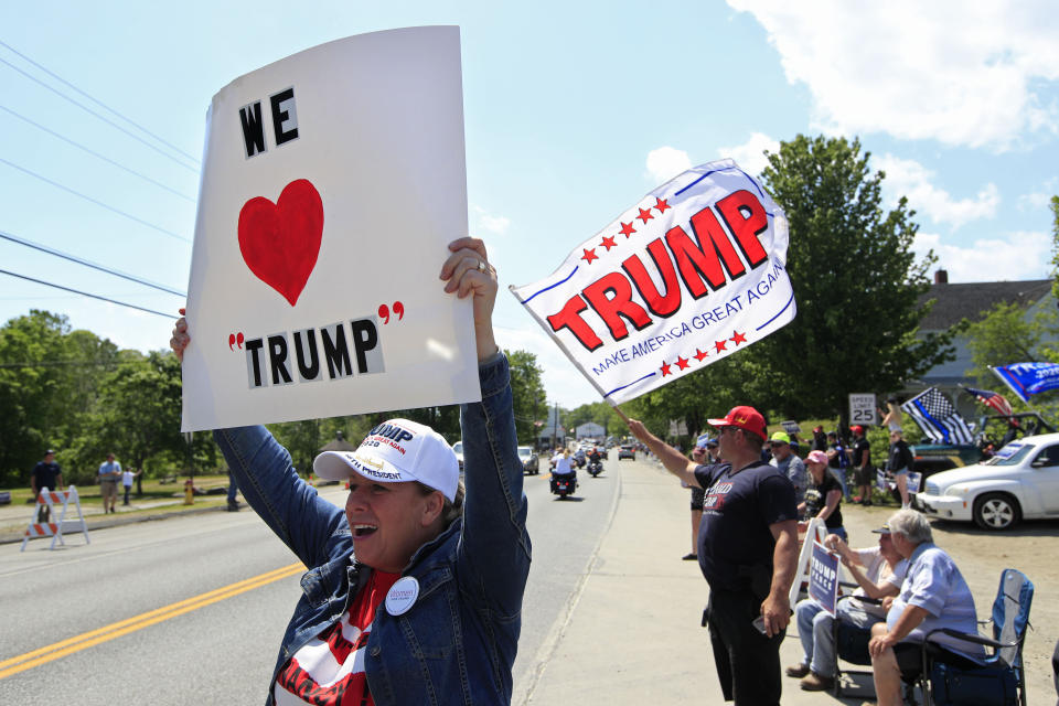 Mikki Buckland, left, and Jim Anderson, both of Friendship, Maine, show support of President Donald Trump, Friday, June 5, 2020, in Guilford, Maine. Trump is visiting Puritan Medical Products, one of the top two makers of testing swabs in the world. (AP Photo/Robert F. Bukaty)