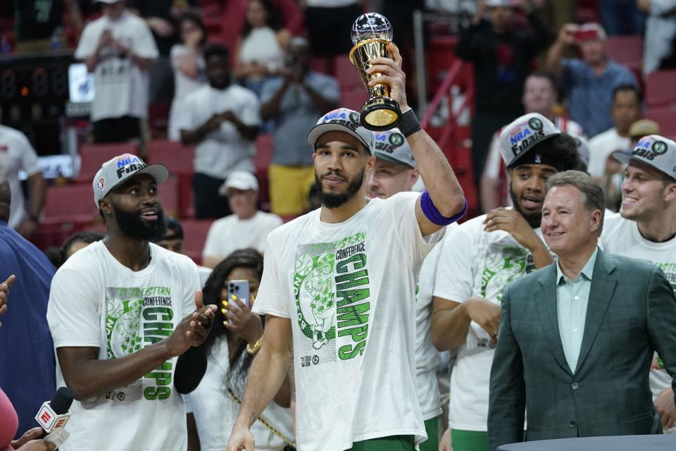 Boston Celtics forward Jayson Tatum raises the NBA Eastern Conference MVP trophy after defeating the Miami Heat in Game 7 of the NBA basketball Eastern Conference finals playoff series, Sunday, May 29, 2022, in Miami. (AP Photo/Lynne Sladky)