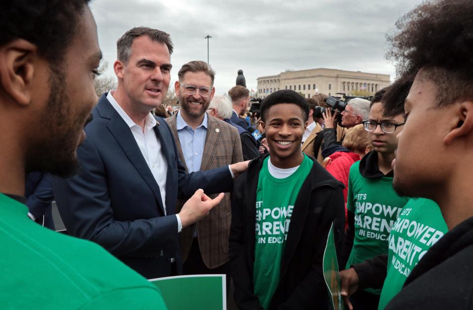 Gov. Kevin Stitt speaks with Kazin Galberth and other students from Tulsa's Crossover Preparatory Academy on Thursday at a pro-school choice rally on the south steps of the Oklahoma state Capitol.
