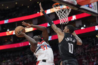 Washington Wizards' Eugene Omoruyi (97) goes up for a shot as Houston Rockets' Jabari Smith Jr. (10) defends during the first half of an NBA basketball game Thursday, March 14, 2024, in Houston. (AP Photo/David J. Phillip)