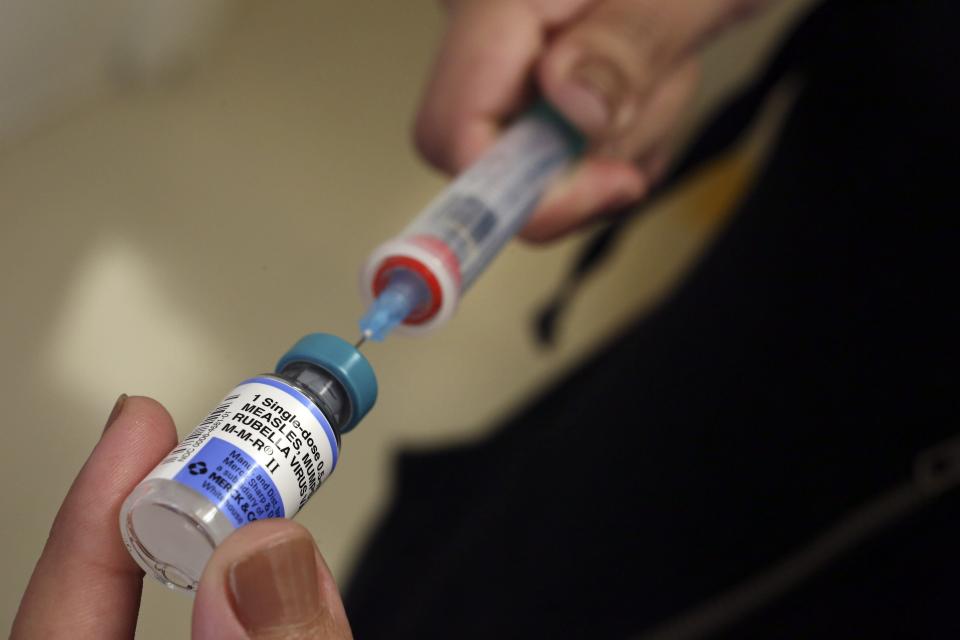 A vial containing MMR vaccines, which protect against measles, mumps and rubella, is loaded into a syringe before being given to a baby in California in 2015.