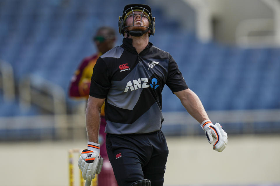 New Zealand's Glenn Phillips leaves the field for 46 runs caught by West Indies's Brandon King during the third T20 cricket match at Sabina Park in Kingston, Jamaica, Sunday, Aug. 14, 2022. (AP Photo/Ramon Espinosa)