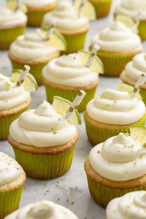 margarita cupcakes with frosting and lime zest and small lime wedges
