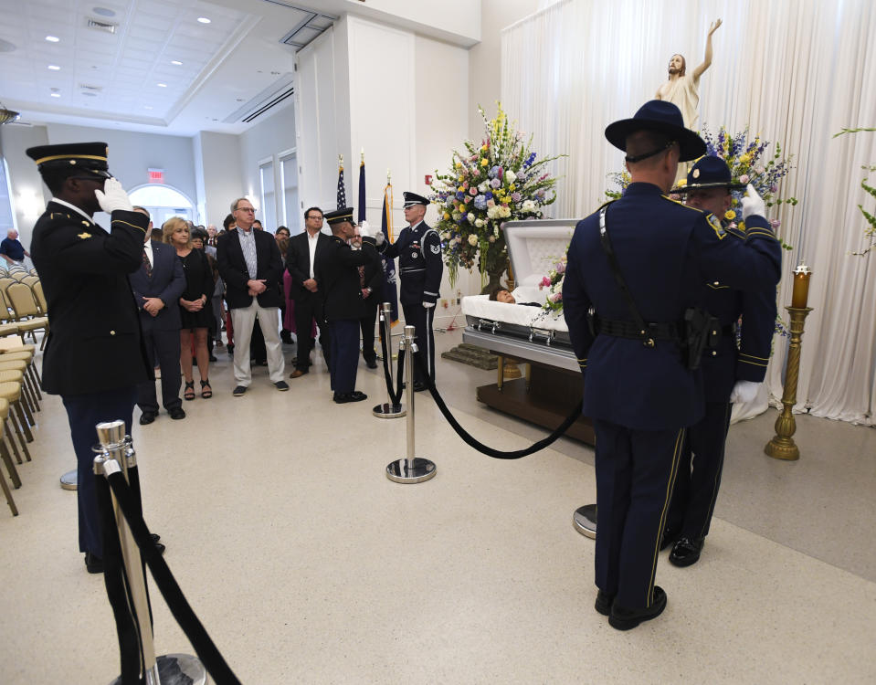 Honor guard members salute the casket of former Louisiana Gov. Kathleen Blanco during a visitation at St. John's Cathedral Hall, Friday, Aug. 23, 2019, in Lafayette, La. Blanco, who served one term as governor and various elected positions across two decades, was in Louisiana’s top job during the destruction of hurricanes Katrina and Rita in 2005. She died a week earlier from cancer. (Brad Kemp/The Advocate via AP)