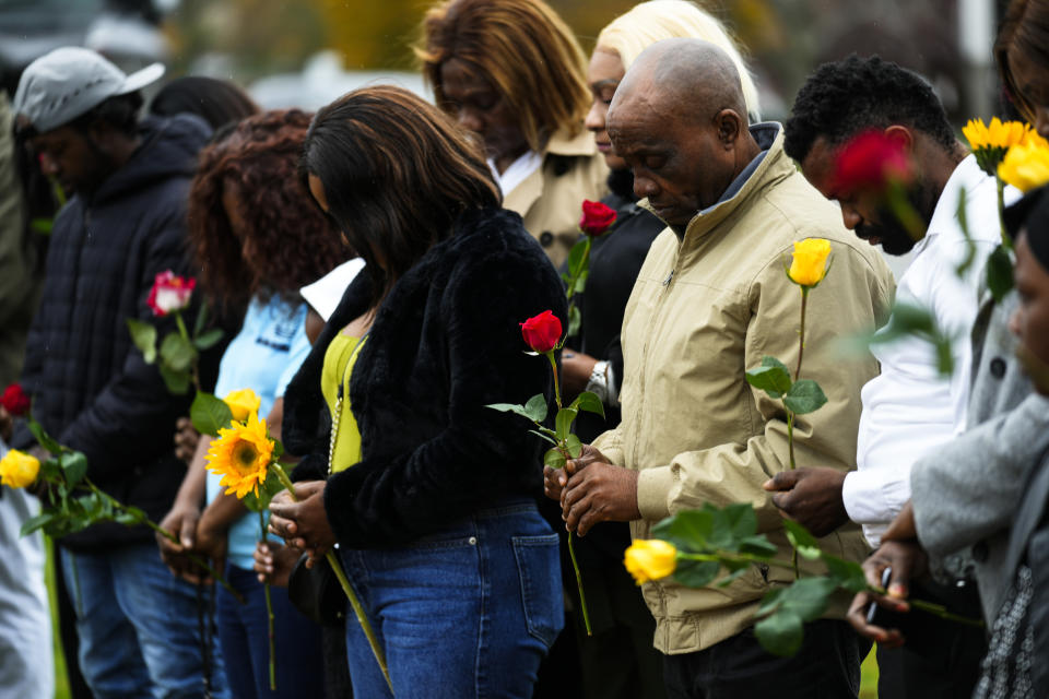 Members of the New Apostolic Church sing a pray at a makeshift memorial outside a bowling alley, the site of one of this week's mass shootings, Sunday, Oct. 29, 2023, in Lewiston, Maine. A gunman killed multiple people at the bowling alley and a bar in Lewiston on Wednesday. (AP Photo/Matt Rourke)