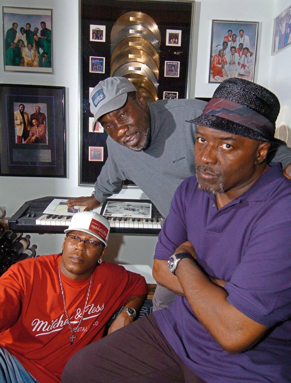 Original members of The O'Jays - Eddie Levert (center) and Walter Williams (right) pose with new member Eric Grant in William's Shaker Heights, Ohio, home Sept. 23, 2004. (AP Photo/Mark Duncan)