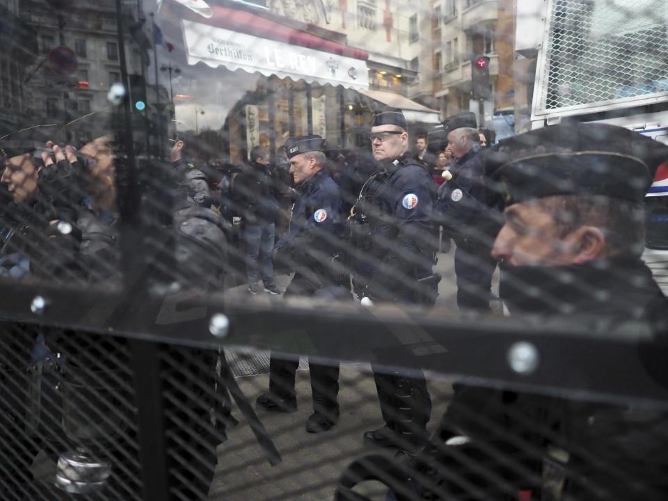 Riot police officers stand along a demonstration against police violence, in Paris, Sunday, March 19, 2017. Protesters carried placards and banners as they gathered at Place de la Republique, a square in the centre of the French capital, to listen to speeches. (AP Photo/Thibault Camus)