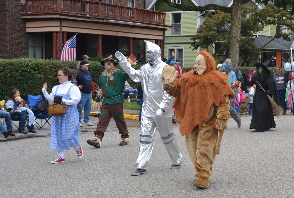 The Wizard of Oz characters — better known as employees of Home Bank — smile and wave to the crowd during the 2018 Fall Foliage Festival Parade.