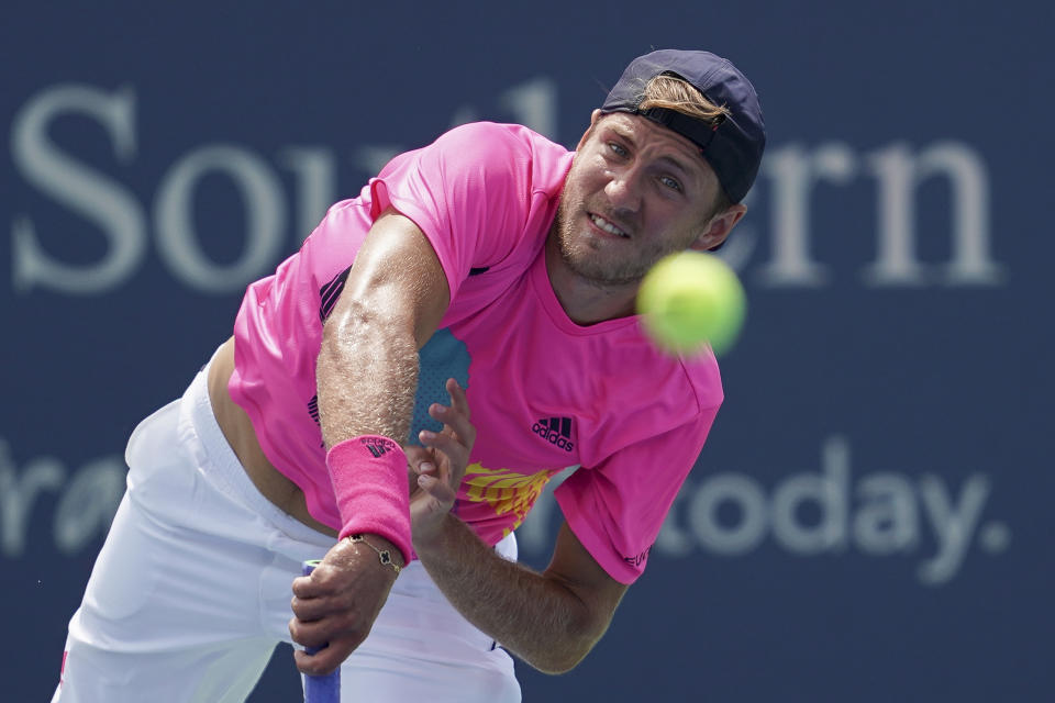 Lucas Pouille, of France, serves to Andy Murray, of Great Britain, in the first round at the Western & Southern Open, Monday, Aug. 13, 2018, in Mason, Ohio. (AP Photo/John Minchillo)