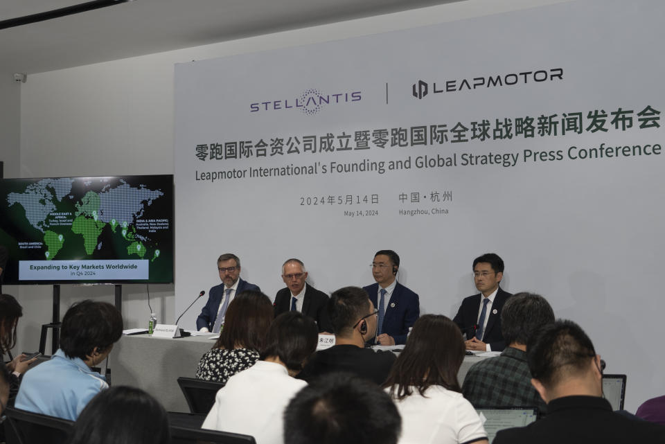 Carlos Tavares, CEO of Stellantis, center left and Zhu Jiangming, founder and CEO of Leapmotor, center right, attend a press conference at a hotel in Hangzhou in eastern China's Zhejiang province on Tuesday, May 14, 2024. European carmaker Stellantis on Tuesday said it had formed a joint venture with the Chinese electric vehicle startup Leapmotor that will begin selling EVs in nine European countries later this year. (AP Photo/Caroline Chen)