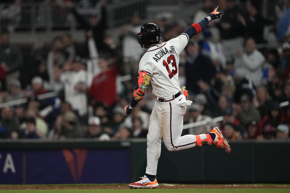Atlanta Braves' Ronald Acuna Jr. gestures to the crowd as he runs the bases after hitting a home run in the sixth inning of the team's baseball game against the Miami Marlins on Wednesday, April 26, 2023, in Atlanta. (AP Photo/John Bazemore)