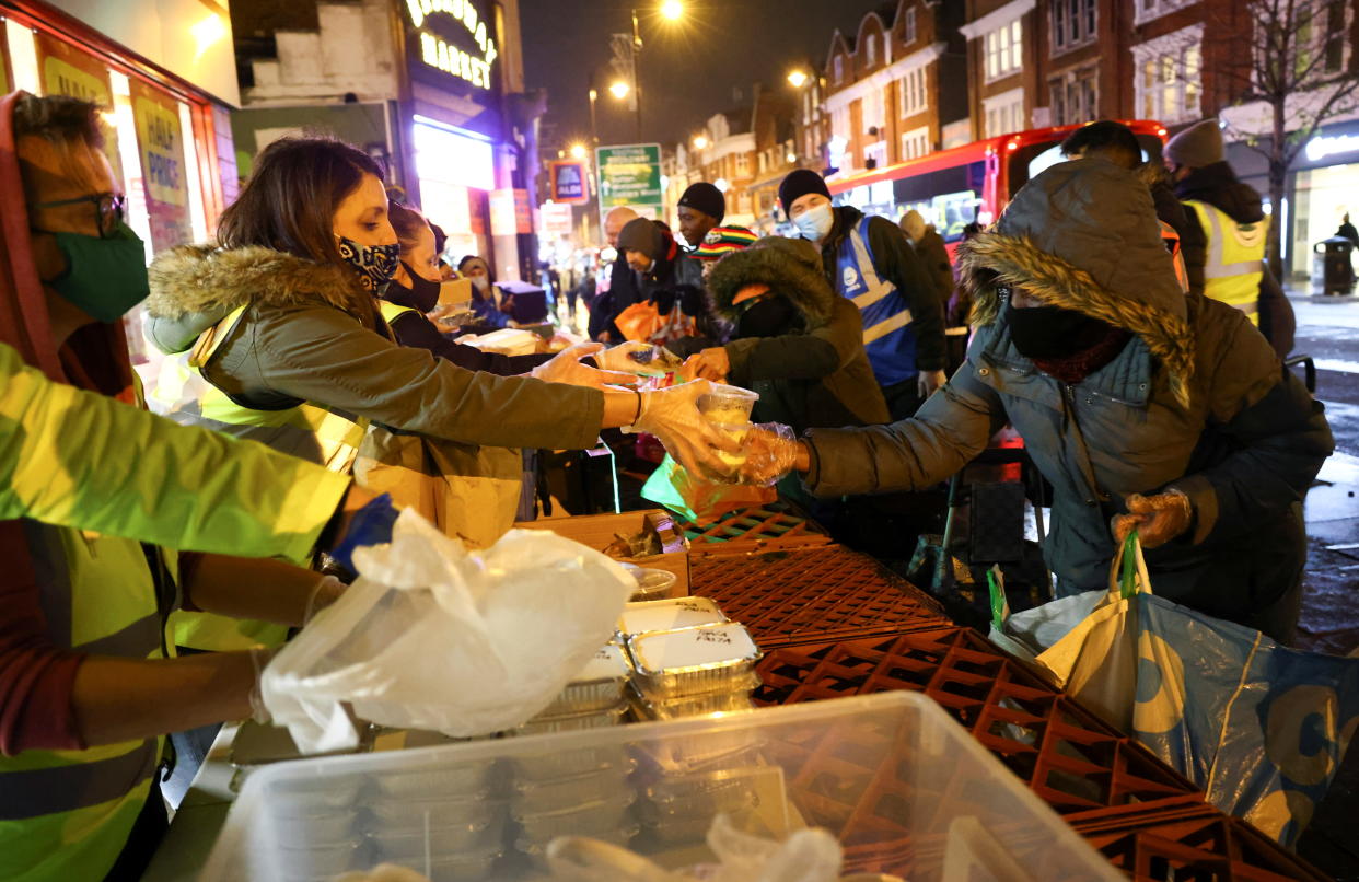 Volunteers working for the Tooting Community Kitchen hand out food donations to those in need, amid the coronavirus pandemic, in Tooting, South London, Britain, November 14, 2020. Picture taken November 14, 2020. REUTERS/Henry Nicholls