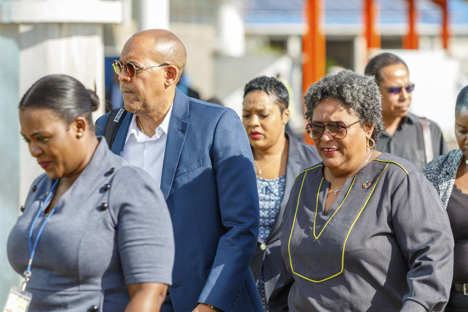 Barbados Prime Minister Mia Mottley, right, and her Foreign Minister Kerrie D. Symmonds, left, arrive at the Argyle International Airport in Argyle, St. Vincent, Thursday, Dec. 14, 2023. Mottley is in St. Vincent to attend a meeting between Venezuela and Guyana presidents over a long-standing dispute over the Essequibo territory, a border region rich in oil and minerals that represents much of Guyana's territory but that Venezuela claims as its own. (AP Photo/Lucanus D. Ollivierre)