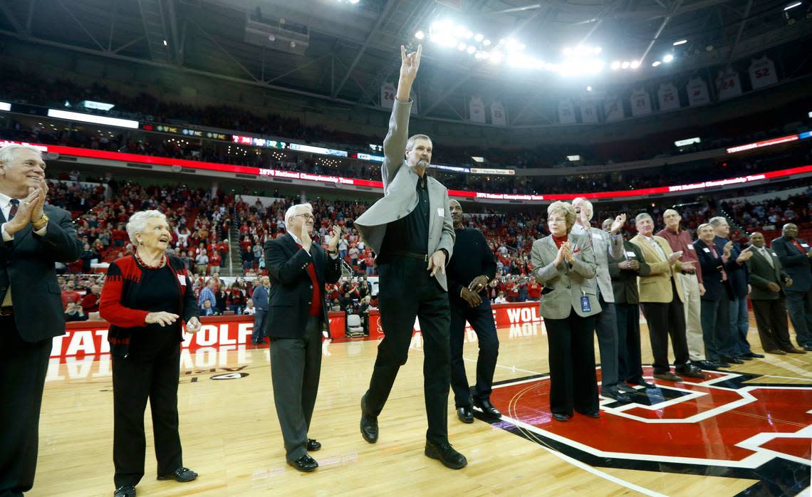 N.C. State’s Tommy Burleson acknowledges the crowd after being introduced as the 1974 National Champions Wolfpack are honored during halftime of N.C. State’s game against Miami at PNC Arena in Raleigh, N.C., Saturday, March 1, 2014.