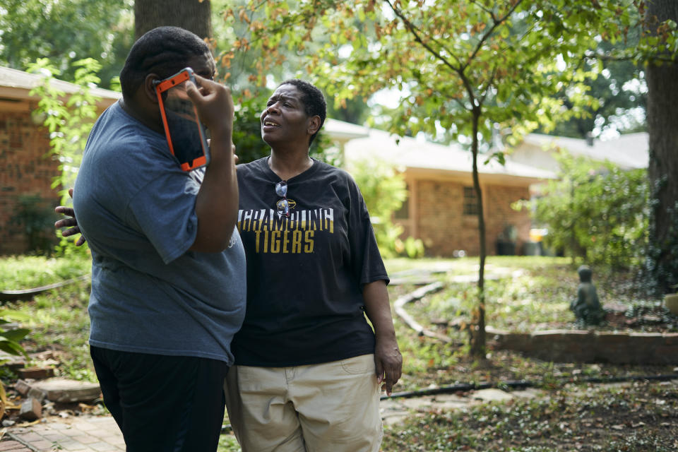 Rosie Phillips talks with her son, J.H., in the backyard at their home in Shreveport. (Photo: Cooper Neill for HuffPost)