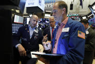 Specialist Mario Picone, left, works with traders at his post on the floor of the New York Stock Exchange, Friday, Aug. 16, 2019. Stocks are opening broadly higher at the end of a turbulent week. (AP Photo/Richard Drew)