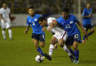 United States' Tyler Adams, center, and El Salvador's Melvin Cartagena, fight for the ball during a qualifying soccer match for the FIFA World Cup Qatar 2022 at Cuscatlan stadium in San Salvador, El Salvador, Thursday, Sept. 2, 2021. (AP Photo/Moises Castillo)