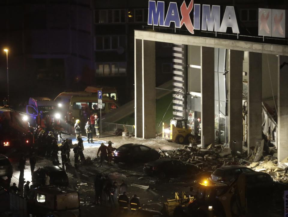 Emergency service specialists work at a store with a collapsed roof in Riga