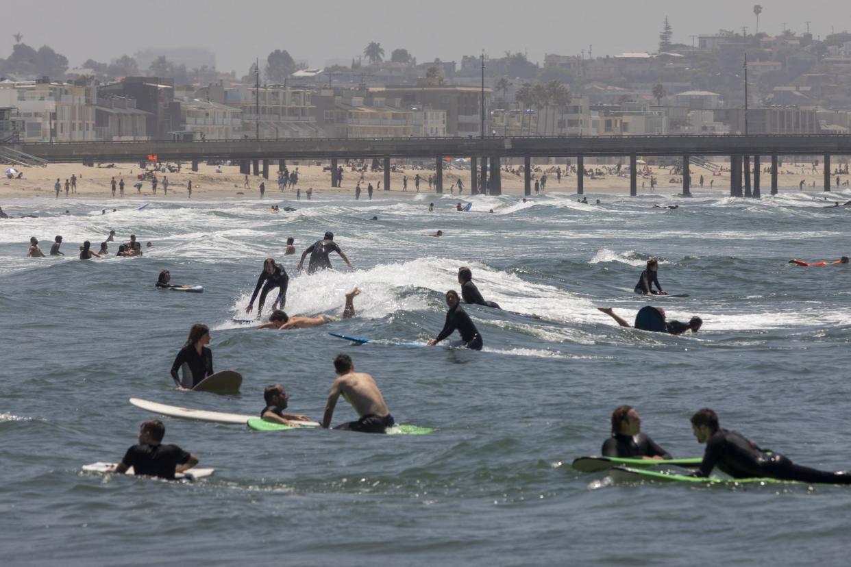 Holiday beachgoers pictured at Venice Beach on Memorial Day as coronavirus safety restrictions continue being relaxed across the state: Getty Images