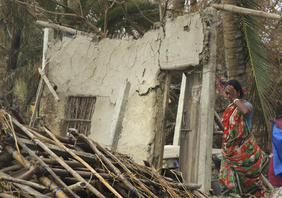 This May 22, 2020 photo shows a woman inspect the damage caused by Cyclone Amphan in Deulbari village, in South 24 Parganas district in the Sundarbans, West Bengal state, India. The cyclone that struck India and Bangladesh last month passed through the Sundarbans, devastating the islands that are home to one of the world’s largest mangrove forests and is a UNESCO world heritage site. (Samrat Paul via AP)