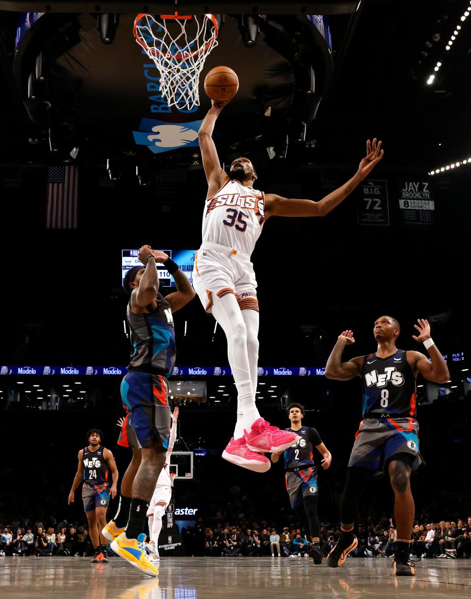 Kevin Durant #35 of the Phoenix Suns dunks against Royce O'Neale #00 of the Brooklyn Nets during their game at Barclays Center on Jan. 31, 2024 in New York City.