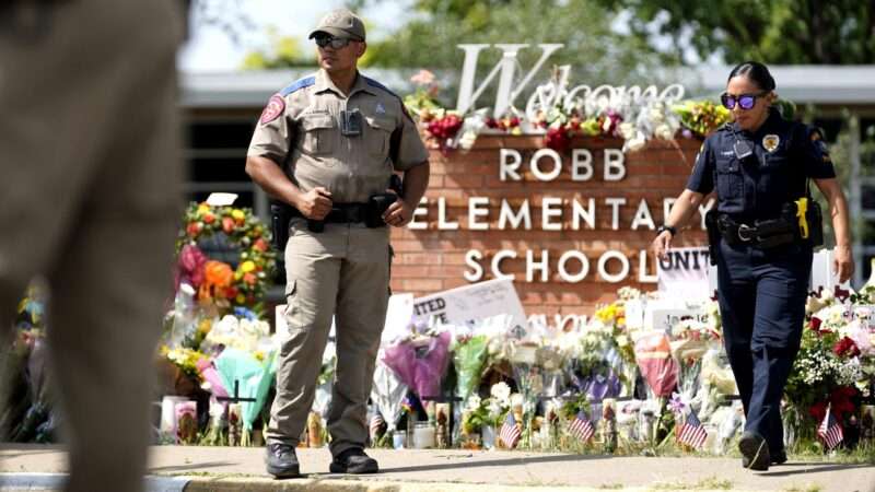 Police officers guarding the location of the Uvalde, Texas school shooting