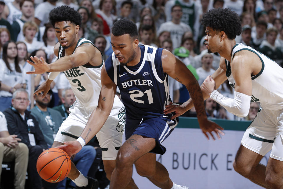 Butler's Pierre Brooks II, center, drives between Michigan State's Jaden Akins, left, and Malik Hall during the first half of an NCAA college basketball game Friday, Nov. 17, 2023, in East Lansing, Mich. (AP Photo/Al Goldis)