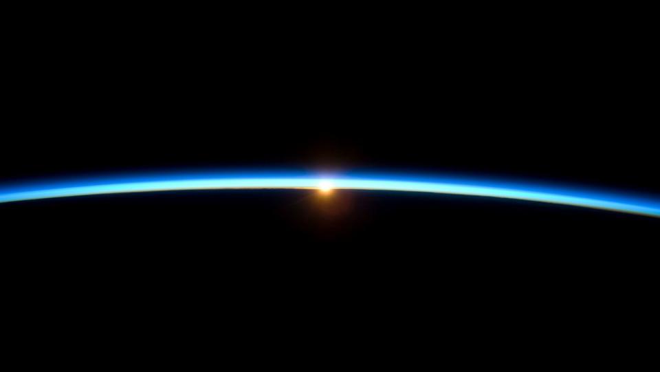 The thin line of Earth's atmosphere and the setting sun are featured in this image photographed by a crew member on the International Space Station while space shuttle Atlantis (STS-129) remains docked with the station. 11/23/09