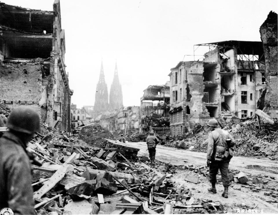 U.S. Troops of the 3rd Armored Division, 1st U.S. Army, advance through the ruins of the city of Cologne, Germany on Mar. 8, 1945. Cologne was one of the German cities the Allies targeted in their strategic bombing campaign.