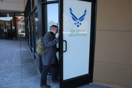 Nicholas Bade, 37, who is among the transgender Americans who this month can enlist openly in the U.S. military for the first time after courts blocked President Donald TrumpÕs effort to re-establish a ban on transgender service members, poses outside a recruitment center in Chicago, Illinois, U.S., January, 4, 2018. Photo taken January 4, 2018. REUTERS/Chris Kenning