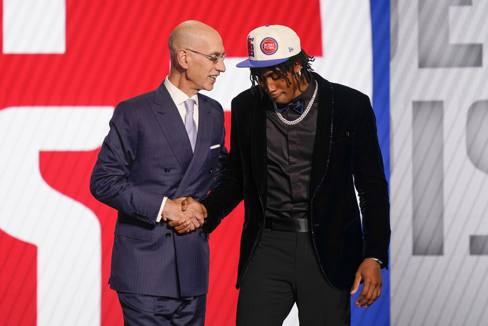 Jaden Ivey, right, shakes hands with NBA Commissioner Adam Silver after being selected fifth overall by the Detroit Pistons in the NBA basketball draft, Thursday, June 23, 2022, in New York. (AP Photo/John Minchillo)