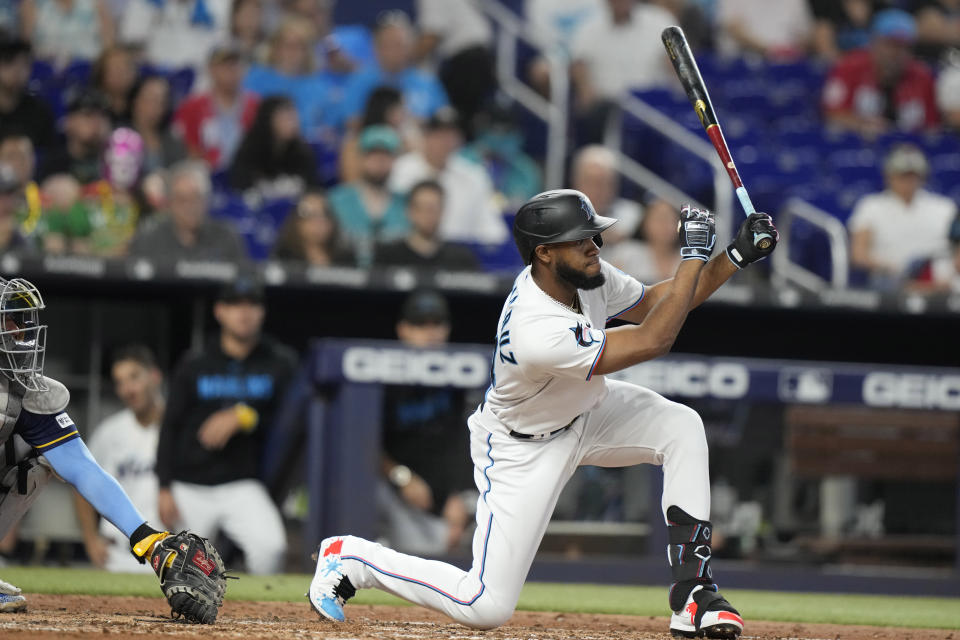 Miami Marlins' Bryan De La Cruz follows through on a RBI single to score two runs during the third inning of a baseball game against the Milwaukee Brewers, Sunday, Sept. 24, 2023, in Miami. (AP Photo/Lynne Sladky)