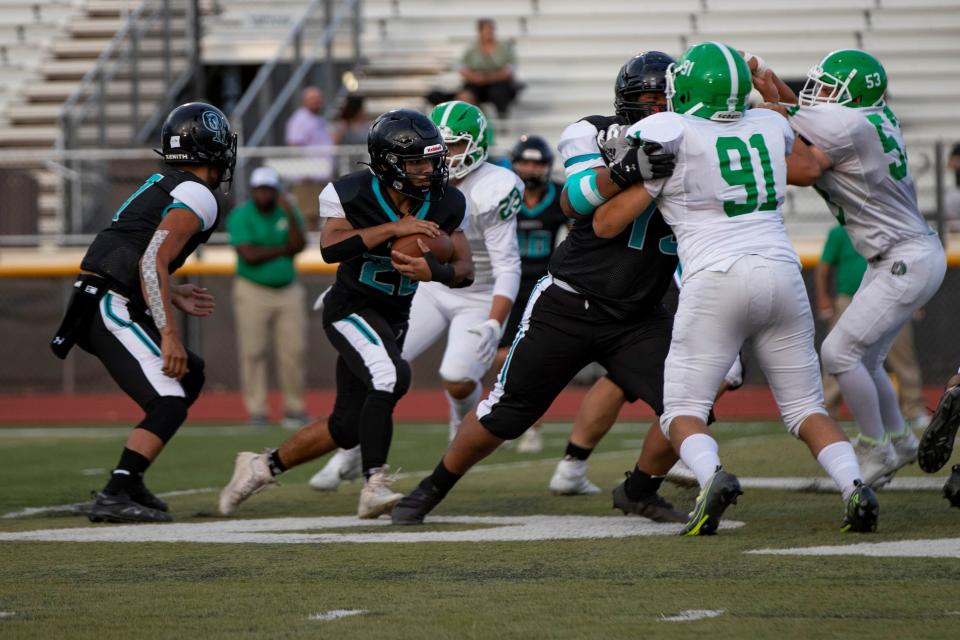 Organ Mountain's Abraham Romero runs the ball during Organ Mountain's football game against Albuquerque at the Field of Dreams on Friday, Aug. 19, 2022. Albuquerque High defeated Organ Mountain 22-20.