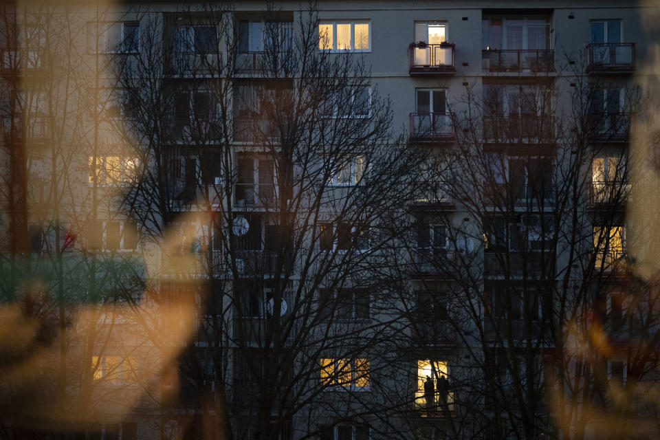 In this Nov. 11, 2018, photo, a couple stands on the balcony of their apartment in Zilina, Slovakia. An investigation by The Associated Press has found that women and their newborns in Slovakia are routinely, unjustifiably and illegally detained in hospitals across the European Union country. (AP Photo/Felipe Dana)