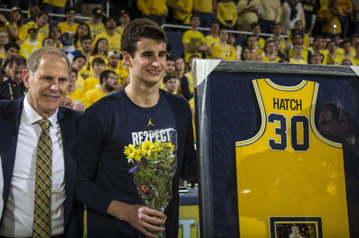 Michigan head coach John Beilein stands with Austin Hatch during senior day celebrations prior to all game against Ohio State. (AP Photo)