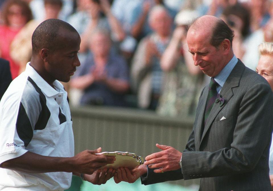 FILE - MaliVai Washington, of the United States, receives the runners-up plate from the Duke of Kent, following the men's singles tennis final at Wimbledon, on July 7, 1996. Frances Tiafoe is the first man from the United States to reach the semifinals at the U.S. Open in 16 years. And he could become the first Black man from the U.S. in a major final since MaliVai Washington was the runner-up at Wimbledon in more than a quarter-century ago. (AP Photo/Gill Allen, File)