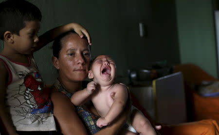 Josemary da Silva, 34, holds 5-month-old Gilberto as her older son Jorge Gabriel, 4 (L), stands by her side at her house in Algodao de Jandaira, Brazil February 17, 2016. REUTERS/Ricardo Moraes