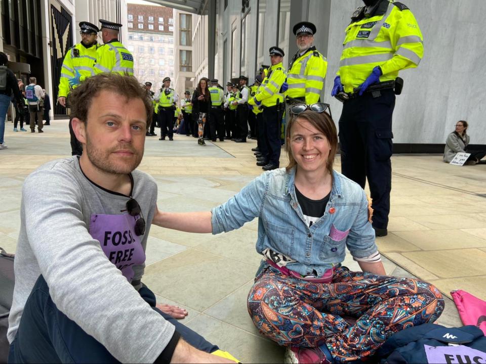 Michael, who did want to give his last name, and Addie May at the Shell HQ protest (Saphora Smith / The Independent)