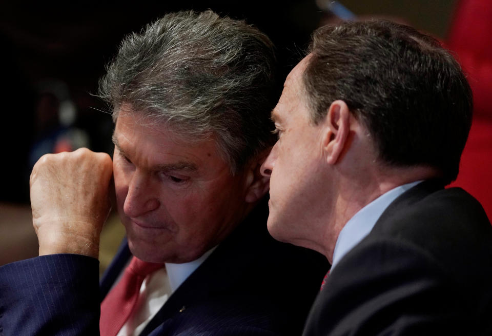 Sen. Joe Manchin (D-W.Va.), left, and Sen. Pat Toomey (R-Pa.) confer as President Donald Trump discusses school and community safety after the Feb. 14, 2018, massacre in Parkland, Florida. The senators are among a bipartisan group talking again with the president about possible gun control legislation. (Photo: Kevin Lamarque / Reuters)
