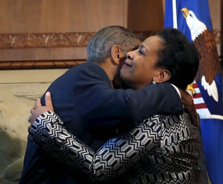 Loretta Lynch (R) embraces her father, Lorenzo Lynch, after being sworn in as the 83rd U.S. Attorney General, and the first black woman to occupy the post, by Vice-President Joe Biden (not pictured) at the Justice Department in Washington April 27, 2015. REUTERS/Gary Cameron