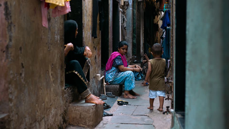 Reshma Prasant Bobde, 42, sits in front of her house in Dharavi on April 14. - Noemi Cassanelli/CNN