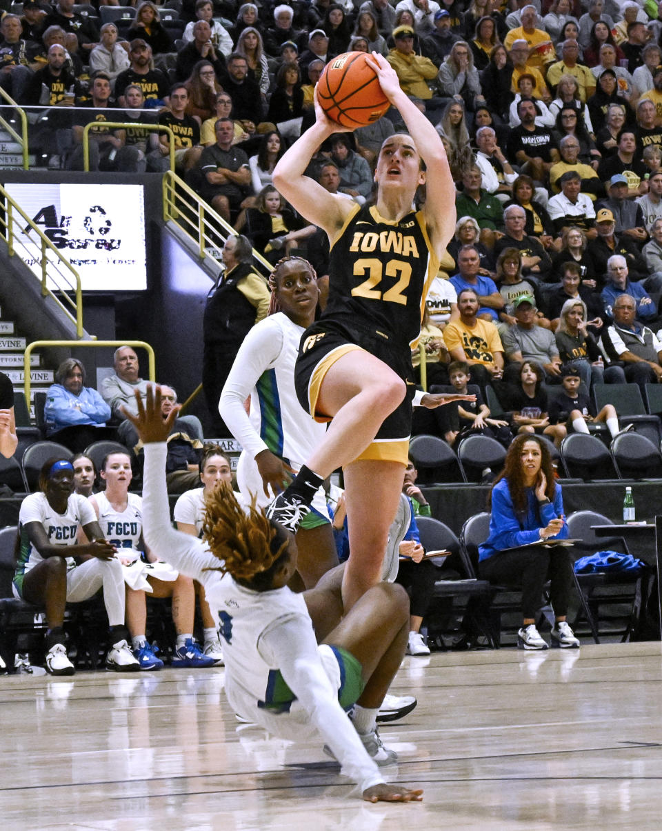 Iowa guard Caitlin Clark (22) shoots over Florida Gulf Coast forward Uju Ezeudu (24) during the first half of an NCAA college basketball game in Gulf Coast Showcase, Saturday, Nov. 25, in Estero, Fla. (AP Photo/Steve Nesius)