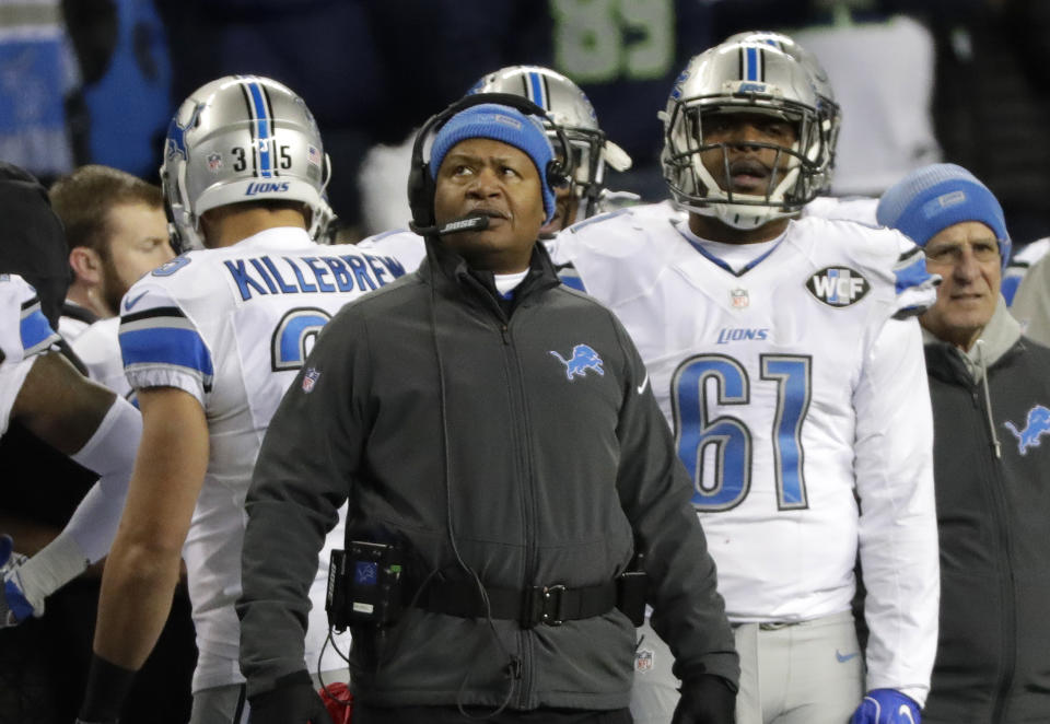 Detroit Lions head coach Jim Caldwell, center, looks toward the scoreboard in the second half of an NFL football NFC wild card playoff game against the Seattle Seahawks, Saturday, Jan. 7, 2017, in Seattle. (AP Photo/Elaine Thompson)