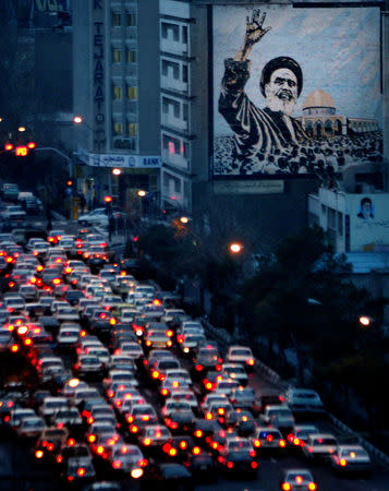 FILE PHOTO: Traffic in evening rush hour moves slowly past a huge mural of founder of Islamic revolution Ayatollah Khomeini in central Tehran, Iran, January 3, 2005. REUTERS/Morteza Nikoubazl/File Photo