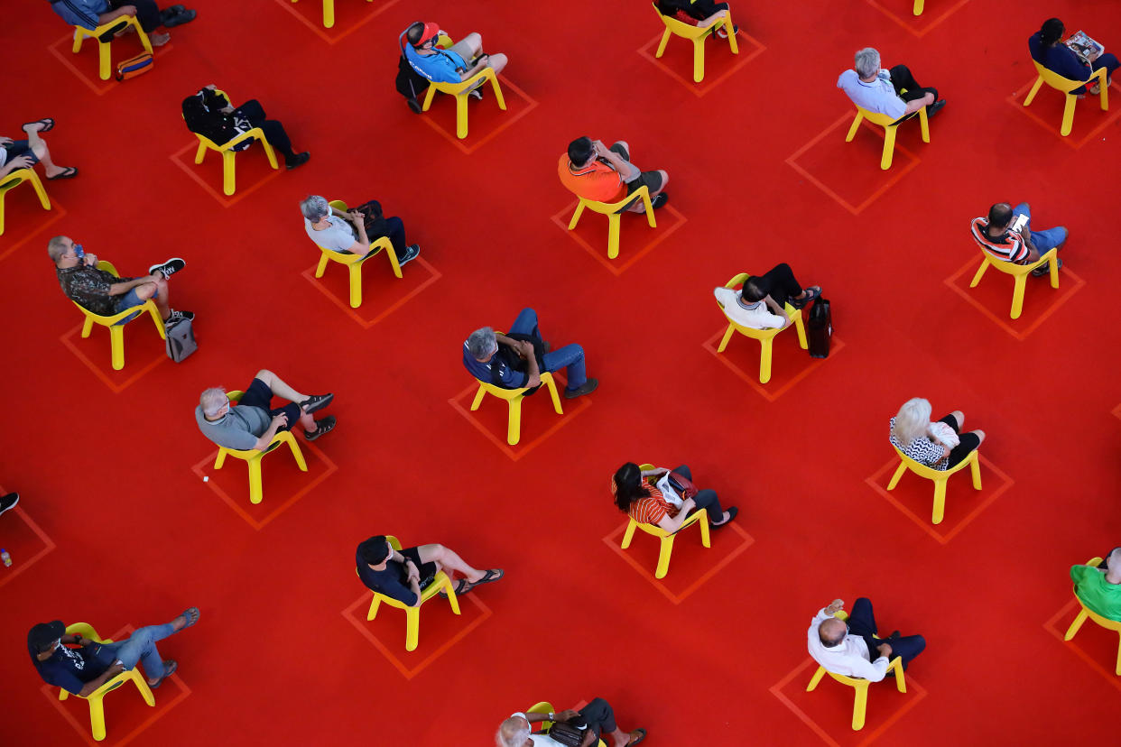 People sit on a chair marked out to keep social distancing amid the COVID-19 pandemic on November 27, 2021 in Singapore. (Photo by Suhaimi Abdullah/NurPhoto via Getty Images)