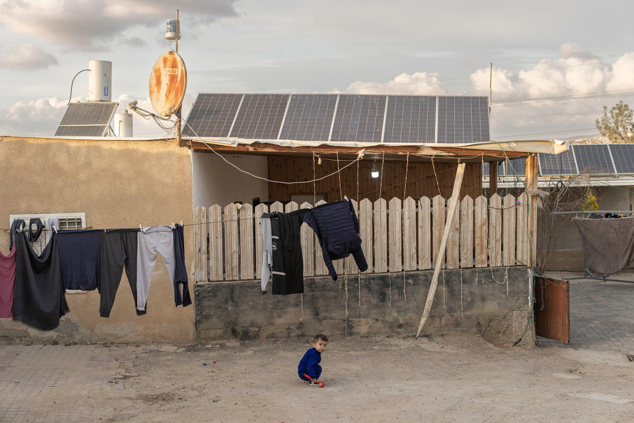 A child plays in front of a home. (Avishag Shaar-Yashuv for NBC News)